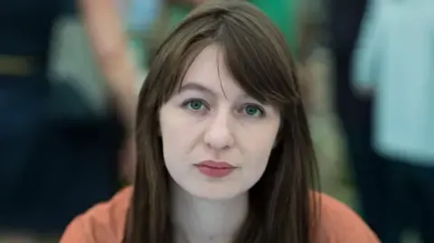 Sally Rooney claims she will not travel to the UK over potential arrest